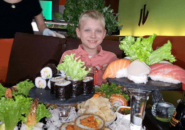 Junge im Sushi-Restaurant