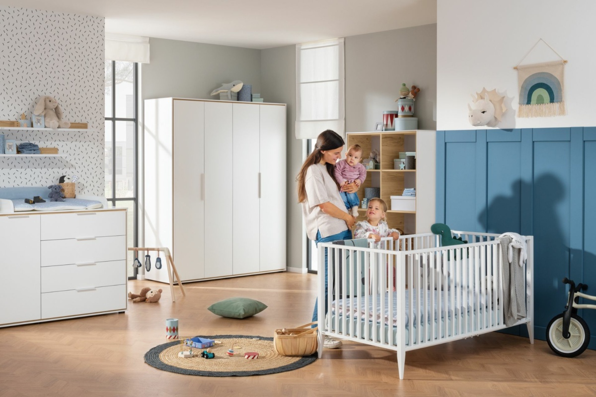 Mutter mit Kind steht im Lieven Babyzimmer